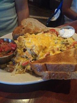 Product: Skillet with sausage, bacon, peppers, mushrooms, onions, cheddar cheese, hash browns underneath - The Brentwood Cafe and Tavern in Southwest Las Vegas, Just off of 215/South Rainbow - Las Vegas, NV American Restaurants
