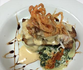 Product: Black Pepper Crusted Black Drum Served over Butter & Chive Whipped Potatoes & Gratinéed Spinach Parmesan, Topped with Crab Hollandaise,
Garnished with Tobacco Onions - The Caboose Restaurant in Located in Beautiful Downtown McComb - McComb, MS Cajun & Creole Restaurant