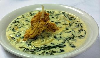 Product: Creamy Spinach & Artichoke Bisque Topped with a Crispy Fried Oyster - The Caboose Restaurant in Located in Beautiful Downtown McComb - McComb, MS Cajun & Creole Restaurant