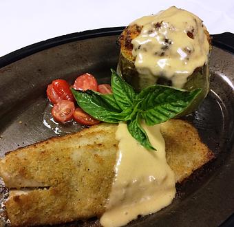 Product: Oven-roasted Speckled Trout Paired with Crab & Crawfish Stuffed Bell Pepper, Drizzled with Hollandaise - The Caboose Restaurant in Located in Beautiful Downtown McComb - McComb, MS Cajun & Creole Restaurant