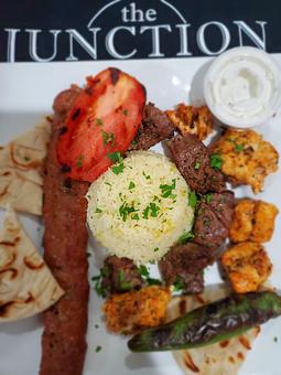 Product: Combination of one skewer chicken shish, one skewer Adana kebab, and one skewer of shish kebab served with rice, salad, grilled tomato, grilled jalapeno. - The Junction Pub & Grill in Nashville, TN Bars & Grills