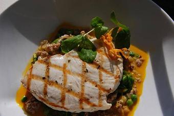 Product: Grilled Montauk Swordfish with sweet italian sausage meat, pea greens, peas, and organic carrot-chive broth - The Plaza Café in Southampton Village - Southampton, NY American Restaurants