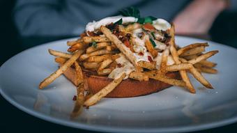 Product: smashed avocado, turkey sausage, french fries, pico, sour cream on rye toast [with added egg $2] - The Pressed Penny Tavern in Kansas City, MO American Restaurants