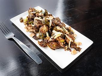Product: Fried brussels sprouts with candied lemon, walnuts, honey & crispy prosciutto bits - The Pressed Penny Tavern in Kansas City, MO American Restaurants