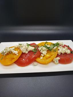 Product: marinated heirloom tomatoes, house made farmers cheese and basil, blended oil - The Pressed Penny Tavern in Kansas City, MO American Restaurants