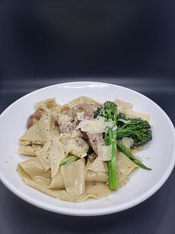 Product: pappardelle pasta, italian sausage, broccolini, shaved parmesan & black pepper - The Pressed Penny Tavern in Kansas City, MO American Restaurants