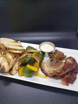 Product: herb brined porchetta with house pickled vegetables Guinness mayo & Boulevard beer
mustard - The Pressed Penny Tavern in Kansas City, MO American Restaurants