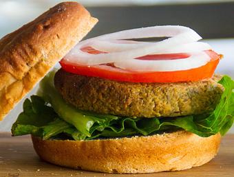 Product: Lentil burger served with lettuce, tomato, onion, beet ketchup on one of our fresh gluten free buns. - The Pureganic Cafe in Downtown Rye - Harrison, NY Jewish & Kosher Restaurant