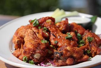 Product: Volcano Sauce Chicken Wings with bleu cheese dressing & celery sticks - Tikis Grill & Bar in Waikiki - Honolulu, HI Bars & Grills