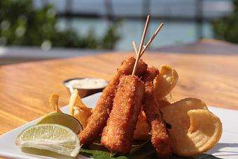 Product: Fish-on-a-stick! Panko-crusted sustainable marlin harvested from island waters. Served with a side of housemade tartar sauce & Sidewinder fries - Tikis Grill & Bar in Waikiki - Honolulu, HI Bars & Grills