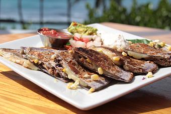 Product: Taro tortillas filled with kalua pig, pepper jack cheese, and Kahuku corn relish served with guacamole and salsa - Tikis Grill & Bar in Waikiki - Honolulu, HI Bars & Grills