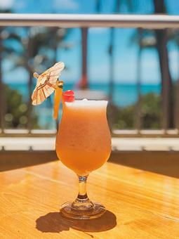 Product: Skyy Watermelon vodka, watermelon liqueur blended with pineapple & coconut, served in a souvenir etched tiki glass. - Tikis Grill & Bar in Waikiki - Honolulu, HI Bars & Grills