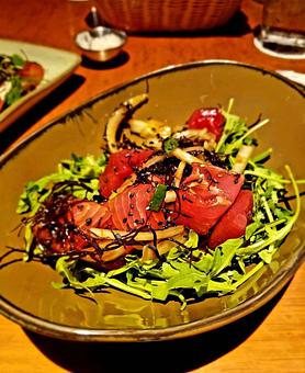 Product: Fresh yellowfin tuna cubed & seasoned with Hawaiian ogo seaweed, soy sauce & sesame oil. Served on a bed of organic baby arugula from the east side of Oahu. A local favorite! - Tikis Grill & Bar in Waikiki - Honolulu, HI Bars & Grills