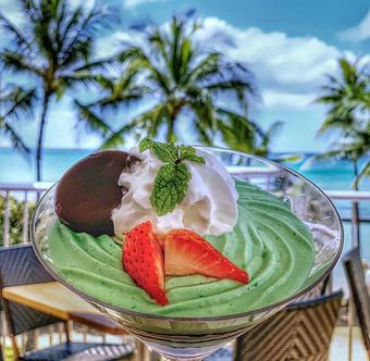 Product: Girl Scout Cookie Grasshopper Parfait. Fluffy housemade mint marshmallow creme layered with Thin Mint cookie crumbles. 50% of all proceeds go toward the Girl Scouts of America! - Tikis Grill & Bar in Waikiki - Honolulu, HI Bars & Grills