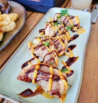 Product: Kalbi Beef Gyoza:
Crunchy dumplings of marinated minced beef tenderloin tips, choi sum, chili aioli. - Tikis Grill & Bar in Waikiki - Honolulu, HI Bars & Grills