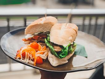 Product: Thai style marinated chicken thighs, Chiang Mai mayo, on a fresh baked hoagie with fresh green papaya salad - Tikis Grill & Bar in Waikiki - Honolulu, HI Bars & Grills