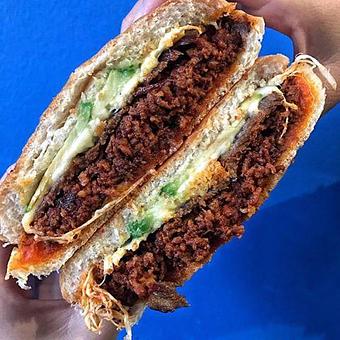 Product: Our Torta Oaxaqueña has beef, chorizo, quesillo (Oaxaca cheese) and avocado - Tlayuda L.A in Los Angeles, CA Latin American Restaurants