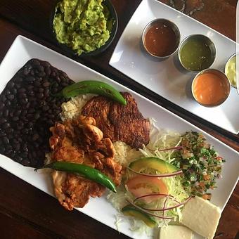 Product: Plato Mixto (mixed plate)
It's has grilled chicken, grilled pork loin (cesina), rice, beans, salad, Pico de gallo, fresh cheese, handmade tortillas, and grilled Cerrano peppers - Tlayuda L.A in Los Angeles, CA Latin American Restaurants