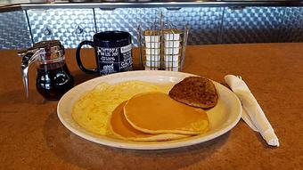 Product: two eggs, two small pancakes and patty sausage - Tommy's Restaurant in Grand Island, NE Sandwich Shop Restaurants