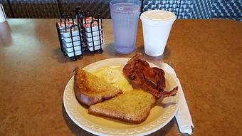 Product: one egg cooked the way you like with one slice of toast and choice of bacon or sausage - Tommy's Restaurant in Grand Island, NE Sandwich Shop Restaurants