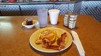 Product: one slice French toast with choice of bacon or sausage - Tommy's Restaurant in Grand Island, NE Sandwich Shop Restaurants