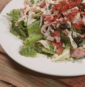 Product: This hearty, nutritious Chef Salad is bursting with high-quality  Ham, Turkey, crispy Bacon, Black Olives, Balsamic Vinaigrette,  and freshly grated Mozzarella cheese. - Townies Pizzeria in Fernandina Beach, FL Italian Restaurants