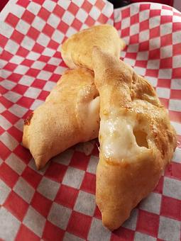 Product: Cheese Puffins are like mini Calzones made from 100% natural products and all natural Mozzarella Cheese.  Kids are sure to love this. - Townies Pizzeria in Fernandina Beach, FL Italian Restaurants