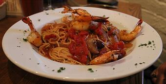 Product: grilled shrimp sauteed with red wine, fresh roma tomatoes, basil, capers, garlic and calamata olives; tossed with angel hair pasta - Two Tony's Restaurant in New Orleans, LA Italian Restaurants