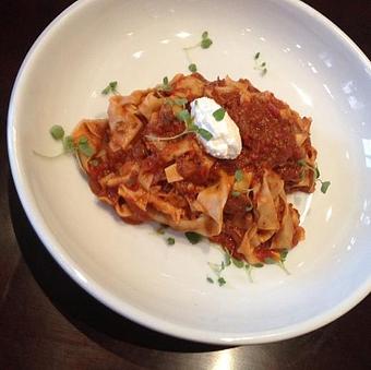 Product: Slow Cooked Lamb Shoulder Bolognese Style, Tagliatelle Pasta, House Ricotta & Lavender Mint. Tagliatelle are long, flat ribbons that are similar in shape to Fettuccine - Vincent Chiccos in Upper King St, in Downtown Charleston - Charleston, SC Italian Restaurants