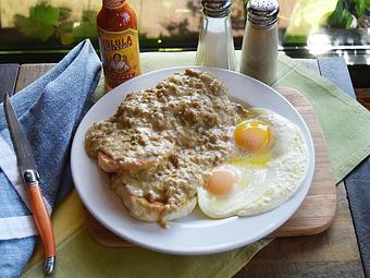 Product: Biscuits & Gravy - Two biscuits smothered in sausage gravy and served with two eggs your way - West Allis Cheese & Sausage Shoppe in West Allis, WI Coffee, Espresso & Tea House Restaurants