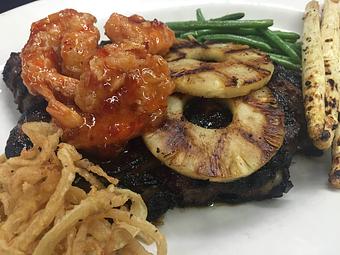 Product: Marinated Ribeye, grilled pineapple, Firecracker Shrimp, garlic mashed potatoes, pan roasted green beans. - Woody's Tupelo in Tupelo, MS Hamburger Restaurants