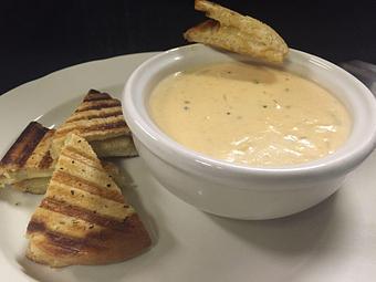 Product: Creamy Tomato Soup with Smoked Gouda/Gruyere 'croutons' - Woody's Tupelo in Tupelo, MS Hamburger Restaurants