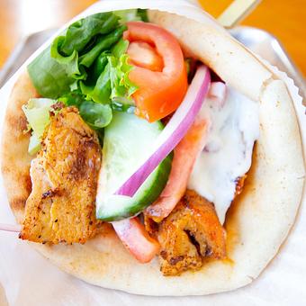 Product: Slow Roasted Chicken Gyro (Shawarma) in a toasty flatbread with fresh veggies yogurt sauce and garlic mayo. - Zendiggi Kebab House in Closter, NJ Middle Eastern Restaurants