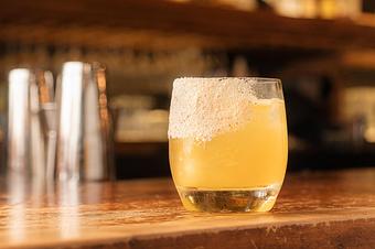Product: A bright yellow cocktail in a short clear glass with white salt on the rim, on a wooden bar top - Lil’ Ba-Ba-Reeba! in River North - Chicago, IL Bars & Grills