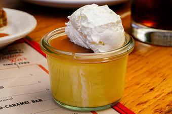 Product: Butterscotch custard in a small glass jar, topped with whipped cream - Lil’ Ba-Ba-Reeba! in River North - Chicago, IL Bars & Grills