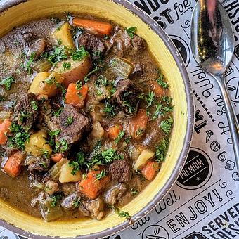 Product: Hearty stew made with Highland Spring Farm grass-fed beef braised in McFleshman’s Dry Irish stout, with local potato, carrot, onion, garlic - Longtable Beer Cafe in Downtown Middleton - Middleton, WI American Restaurants