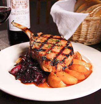 Product: Grilled Double Cut Pork Chop, Roasted Red Potatoes, Red Cabbage, Caramelized Apples and Calvados Sauce - 39 Rue de Jean in Historic Downtown Charleston - Charleston, SC French Restaurants