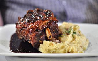 Product: Braised Pork Shank with Sweet Potato Puree and Port Demi-Glace - Acqua Restaurant-White Bear Lake in White Bear Lake, MN Bars & Grills