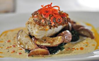 Product: King Crab Encrusted Certified Chilean Sea Bass with Roasted Potatoes and Chile Beurre Blanc - Acqua Restaurant-White Bear Lake in White Bear Lake, MN Bars & Grills