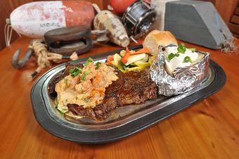 Product: AJ's Signature Blackened Ribeye topped with our Shrimp & Cajun Cream Sauce - AJs Seafood & Oyster Bar in West Destin - Destin, FL Seafood Restaurants
