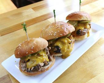 Product: Slow smoked all natural pork shoulder, brioche bun, tangy mustard sauce - Ashley's Restaurant in Across from the University of Michigan Campus in the heart fo the State Street Shopping District. - Ann Arbor, MI American Restaurants