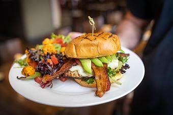 Product: Grilled chicken breast, melted Swiss cheese, Applewood smoked bacon, avocado, lettuce, tomato, ranch dressing, toasted brioche bun - Back Bistro in Palladio - Folsom, CA American Restaurants