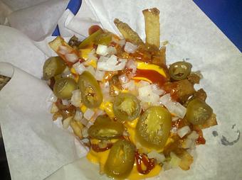 Product: Big Larry's famous fresh cut fries Smothered in Chili and Cheese with onion, jalapenos, and ketchup! - Big Larry's Burgers in Valley Center, KS Hamburger Restaurants
