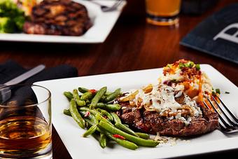 Product: A tender USDA Choice center cut sirloin seasoned and grilled to perfection. Smothered with grilled onions, mushrooms and melted mozzarella cheese. - Big Whiskey's American Restaurant & Bar in Springfield, MO Bars & Grills
