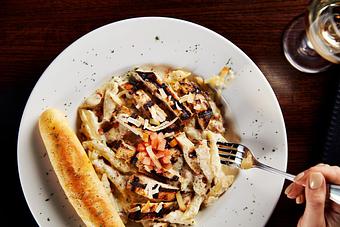 Product: Our original ranch alfredo sauce tossed with penne pasta and crisp bacon. Topped with tender grilled chicken, diced tomatoes and smoked Gouda cheese. - Big Whiskey's American Restaurant & Bar in Springfield, MO Bars & Grills