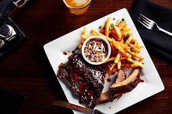 Product: A Whiskey’s favorite. Slow cooked pork ribs chargrilled and basted with our honey whiskey BBQ sauce. Served with loaded french fries and BBQ slaw. - Big Whiskey's American Restaurant & Bar in Springfield, MO Bars & Grills