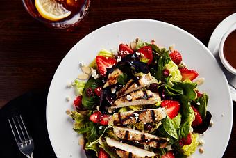 Product: Sliced strawberries, toasted almonds, sun-dried craisins, sunflower seeds and Gorgonzola cheese over fresh salad greens. Served with balsamic vinaigrette and topped with tender strips of grilled chicken. - Big Whiskey's American Restaurant & Bar in Springfield, MO Bars & Grills