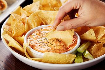Product: Shredded chicken, cream cheese and buffalo sauce blended together. Served with warm tortilla chips and celery. - Big Whiskey's American Restaurant & Bar in Springfield, MO Bars & Grills