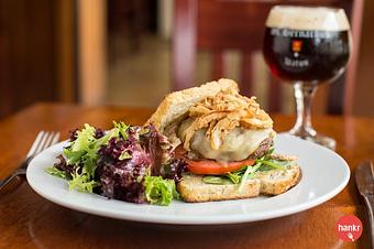 Product: Highland Spring Farm Scottish Highland Beef, Muenster, Beer Battered Onion Straws, Spinach, Tomato, Classic Aioli, on Madison Sourdough Bread - Brasserie V in Madison, WI French Restaurants