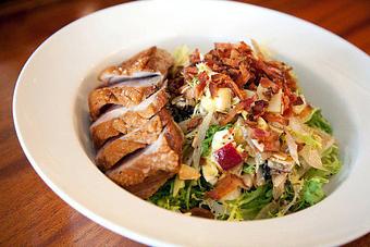 Product: Frisée, Grilled Endive, Crumbled Egg, Apple, Almond, Warm Bacon, Apple Cider Vinaigrette. Recommended with duck breast. - Brasserie V in Madison, WI French Restaurants